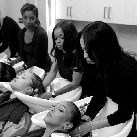 Guests receiving scalp treatments at wash basins