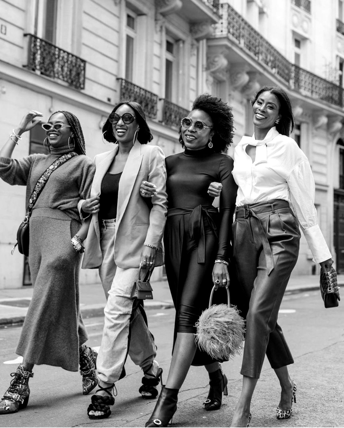 Four women walking together on a city street
